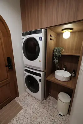 a washing machine and a microwave in a bathroom at The Shantipan Mandala - Cozy City Retreat 400m from BTS Station in Bangkok