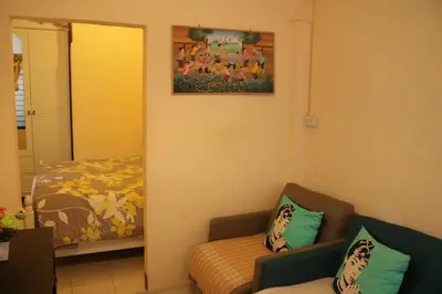 a living room with a couch and a bed at Eco House in Bangkok