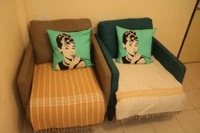 two beds with a picture of a boy on them at Eco House in Bangkok