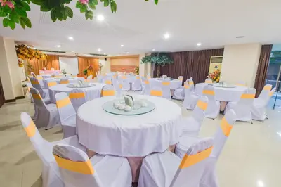 a banquet hall with white tables and white chairs at Three Seasons Bangkok in Bangkok