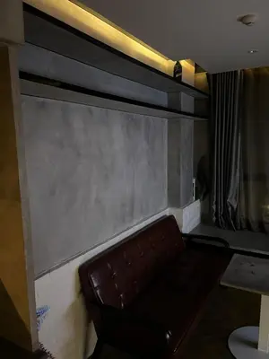 a brown leather couch sitting in a room at Spaceous Appartment on Sukhumvit in Bangkok