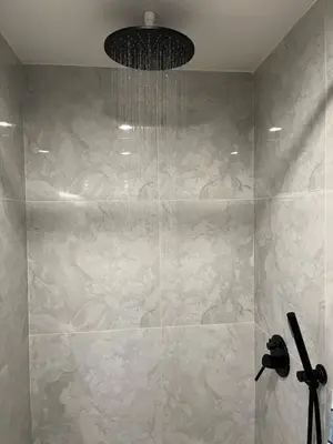 a bathroom with a shower with a chandelier at Spaceous Appartment on Sukhumvit in Bangkok