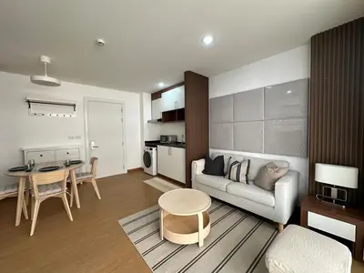 a living room with a couch and a table at 6th Avenue Sukhumvit BKK Two Bedrooms BTS Asok Nana MRT Sukhumvit in Bangkok