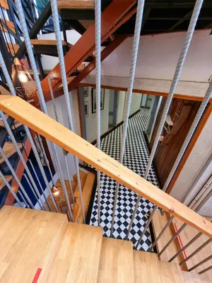 an overhead view of a wooden staircase with wooden floors at Friend Nest Bangkok in Bangkok