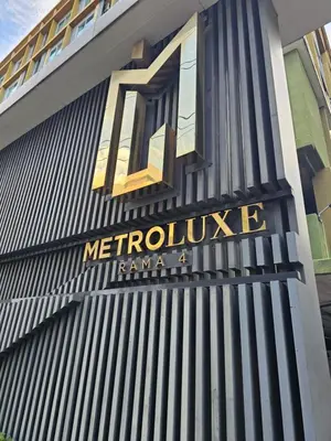 a sign on the side of a building at Metroluxe rama4 , city center in Bangkok