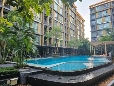 a large swimming pool in front of a building at Metroluxe rama4 , city center in Bangkok