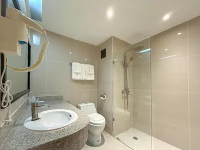 a bathroom with a sink and a toilet and a shower at Avana Residence in Bangna