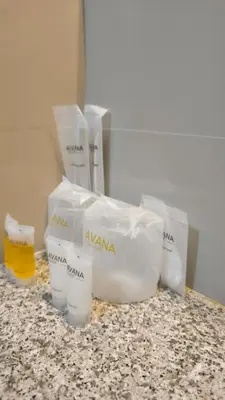 a counter with a bunch of white containers on it at Avana Residence in Bangna