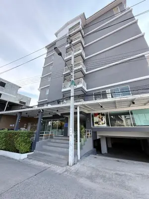 a street sign in front of a building at Prestige in Bangna