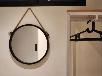 a mirror hanging on a wall next to a door at Be Cozy Silom Modern 2BR 1-min to BTS & MRT in Bangkok