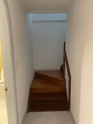a hallway with a staircase with wooden floors at Kin Bangkok in Bangkok