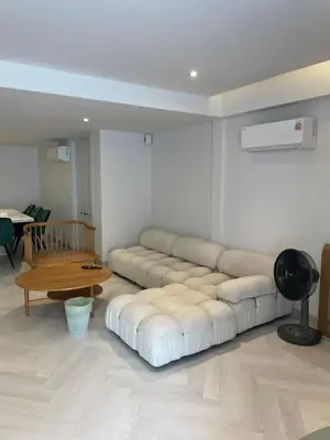 a living room with a couch and a table at Kin Bangkok in Bangkok
