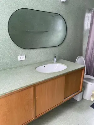 a bathroom with a sink and a mirror on the wall at Kin Bangkok in Bangkok