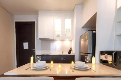 a kitchen with a table with plates and candles on it at Luxury Condo with Swimming Pool, Fast Wifi, 711, Big Room, Jacuzzi in Bangkok