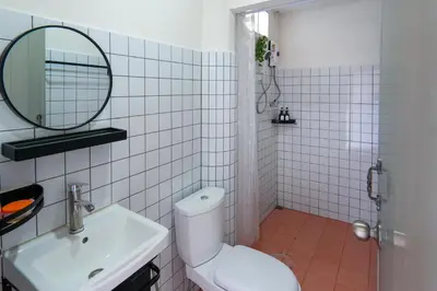 a bathroom with a toilet and a sink and a mirror at Baan ABC at 112 Phahonyothin 55 in Bang Khen