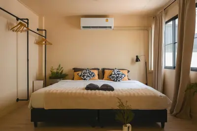 a bedroom with a bed with two hats on it at 4BR 10PAX 2min 7Eleven & 7min Commons Thonglor in Sathani Khlong Tan