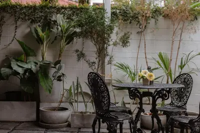 a patio with a table and chairs and plants at 4BR 10PAX 2min 7Eleven & 7min Commons Thonglor in Sathani Khlong Tan