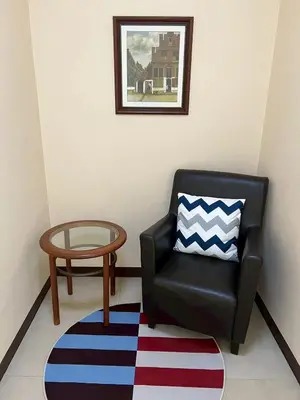 a black chair and a table in a room at Everything Within Minutes House in Bangkok