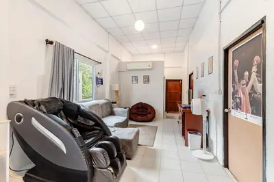 a living room with a couch and a chair at Room 1 Homestay Near BTS Bangwa & Train Muaythai in Bangkok