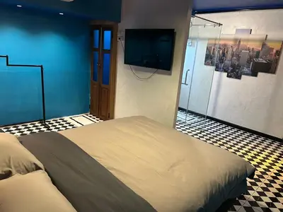 a bedroom with a bed and a flat screen tv at The oasis on 8 City blue 2