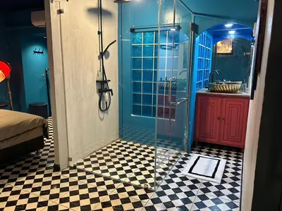 a bathroom with a shower with a glass door at The oasis on 8 City blue 2