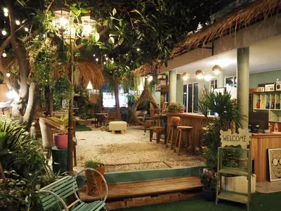 a restaurant with tables and chairs and plants at The oasis on 8 City blue 2