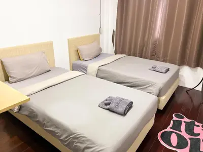 two beds with towels on them in a room at 4BR 8PAX Near BTS Mochit MRT Chatuchak Union Mall in Sathani Bang Su