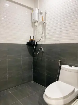a bathroom with a shower and a toilet in it at 4BR 8PAX Near BTS Mochit MRT Chatuchak Union Mall in Sathani Bang Su