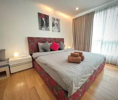 a bedroom with a bed with two stuffed animals on it at Cozy Private Home I Steps to BTS & MRT Sukhumvit Minimum 14 nights in Bangkok
