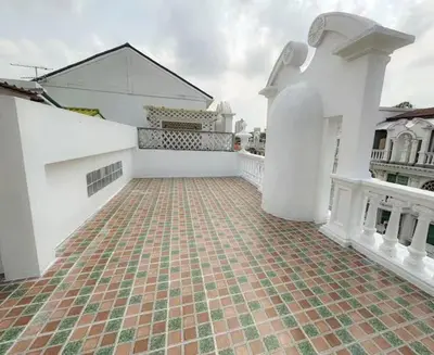 an empty courtyard of a white house with a brick floor at 4BR 10PAX Ensuite Near EmQuartier Emporium Emsphere in Khlong Toei
