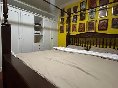 a bedroom with a large bed with yellow walls at The oasis on 8 3 bedrooms private zone in Bang Kapi