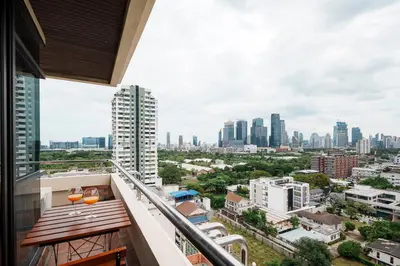a balcony with a view of the city at KingBed|BTS&Park»5min|ParkView|Gym|Washer|FastWiFi in Khlong Toei