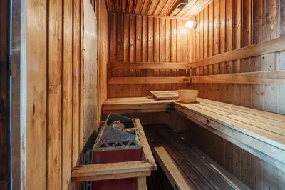 an inside of a wooden sauna with a box in it at Quiet Asoke/Nana BTS Retreat w/ Skyline & Gym/Park in Khlong Toei