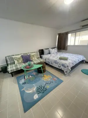 a living room with a couch and a bed and a table at Lazy Ma-fia C3 Andy in Ban Song Hong