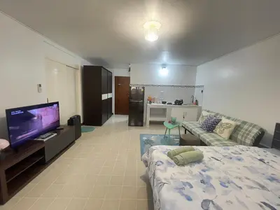 a living room with a bed and a flat screen tv at Lazy Ma-fia C3 Andy in Ban Song Hong