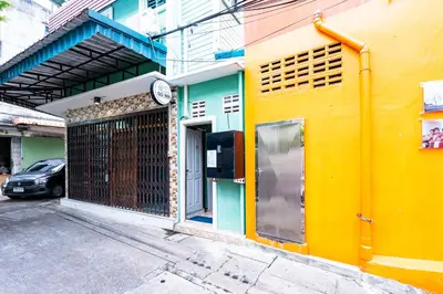 a building with a clock on the side of it at xxGO INN The Giant Swing - โกอินน เสาชิงช้า in Bangkok