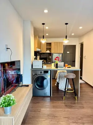a kitchen with a washer and dryer in a room at Common Living Ekkamai in Bangkok