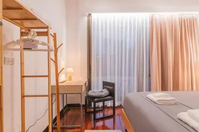 a bedroom with a bed and a desk and a ladder at MRT-Accessible & Delightful Family Hub! in Bangkok