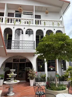 a building with a table and chairs in a courtyard at Bangkok Neighborhouse in Bangkok