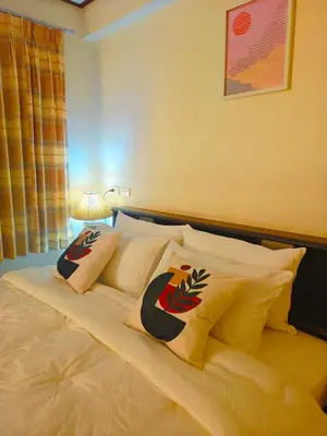 a bed with pillows on it in a bedroom at At Sathon apartment in Bangkok