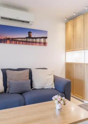 a living room with a blue couch and a pier at Downtown Spacious Luxury Condo BKK- 5 mins BTS! in Bangkok