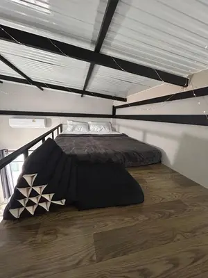 a large bed in a room with a ceiling at Munchies Bed & Breakfast in Bangkok