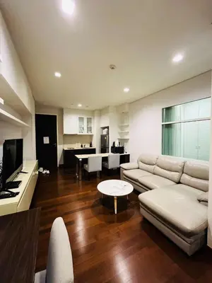 a living room with a white couch and a table at Thong Lor Luxury condo with Swimming Pool, Fast Wifi in Sathani Khlong Tan