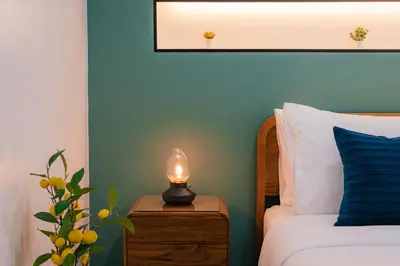 a bedroom with a bed and a candle on a night stand at EXCLUSIVE SUKHUMVIT RESIDENCE, 3 Min BTS, Thonglor, 20 Guests in Bangkok