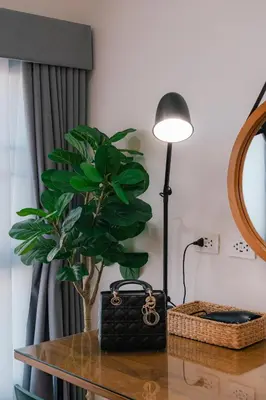 a table with a black purse and a plant on it at EXCLUSIVE SUKHUMVIT RESIDENCE, 3 Min BTS, Thonglor, 20 Guests in Bangkok
