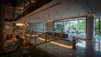 a large living room with a couch and a table at Life asoke rama 9 in Bangkok