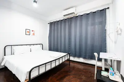 a bedroom with a bed and a black curtain at xx BAO The Giant Swing - เสาชิงช้า ศาลเจ้าพ่อเสือ 1 in Bangkok
