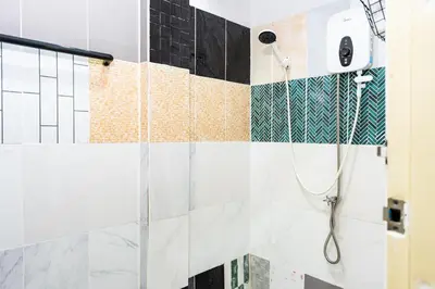 a bathroom with a shower with black and white tiles at xx BAO The Giant Swing - เสาชิงช้า ศาลเจ้าพ่อเสือ 1 in Bangkok