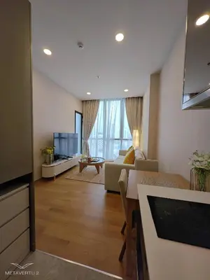 a living room with a couch and a tv at Brand New 2 bedroom near Paragon in Pratunam