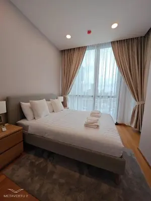 a bedroom with a large bed and a large window at Brand New 2 bedroom near Paragon in Pratunam